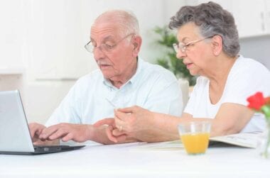 Elderly man and woman working on a VA lay statement.