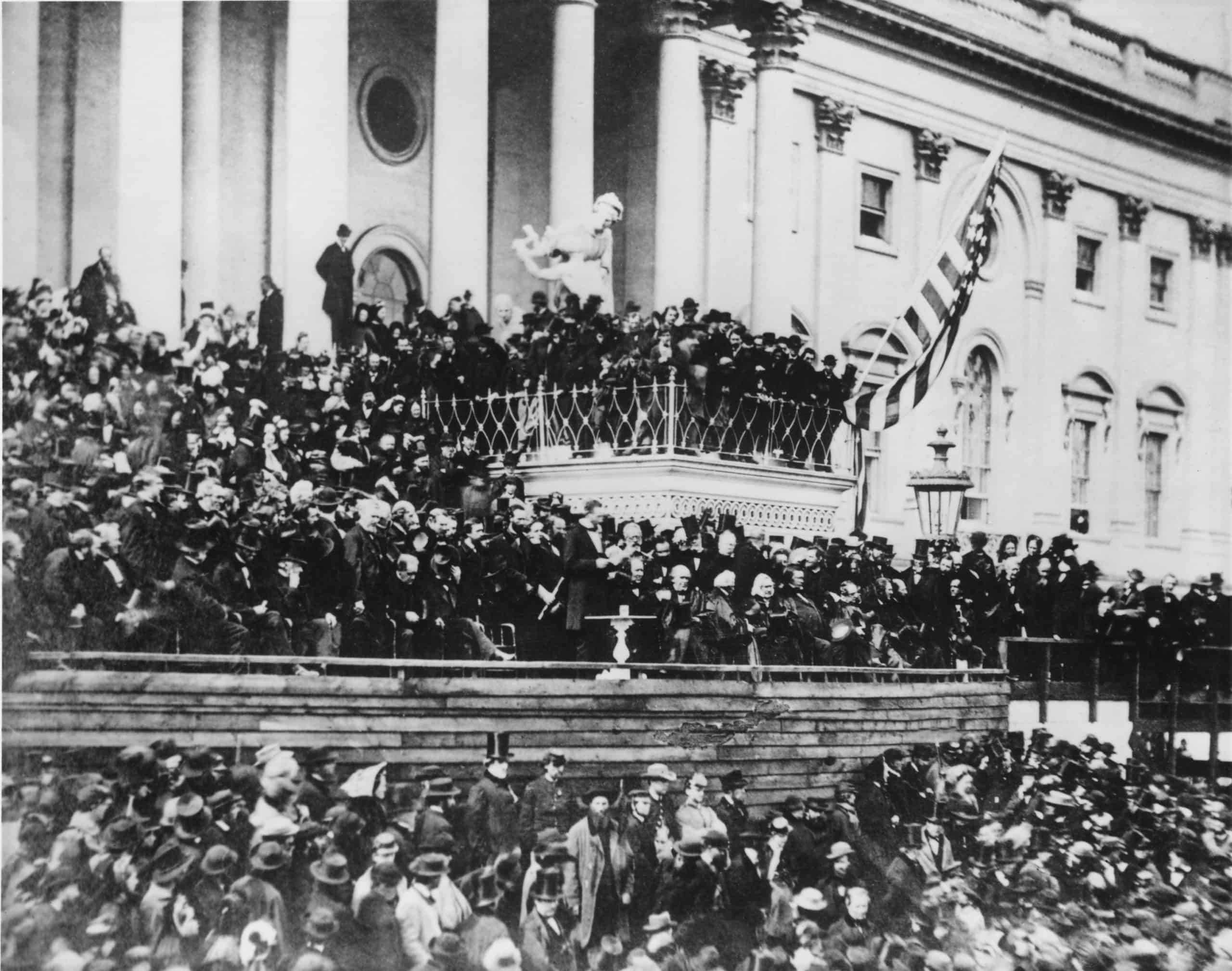 Abraham Lincolns delivering his second inaugural address standing center on the east portico of the U.S. Capitol March 4 1865 his second inauguration. scaled