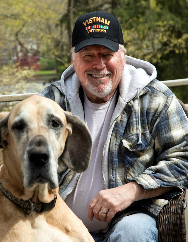 Vietnam veteran smiles with dog