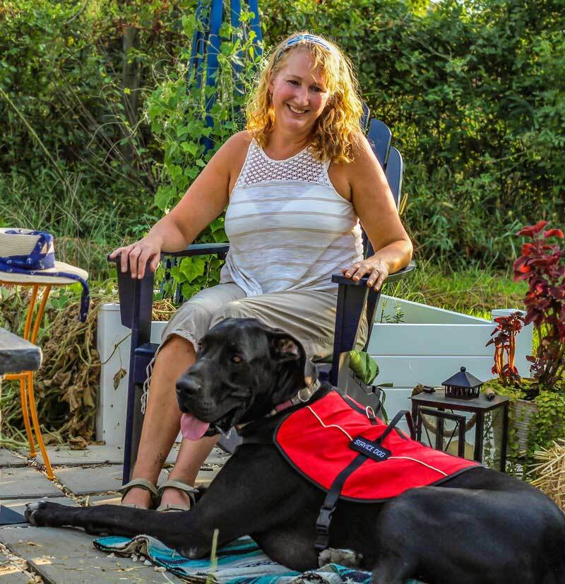 Woman smiles at her service dog