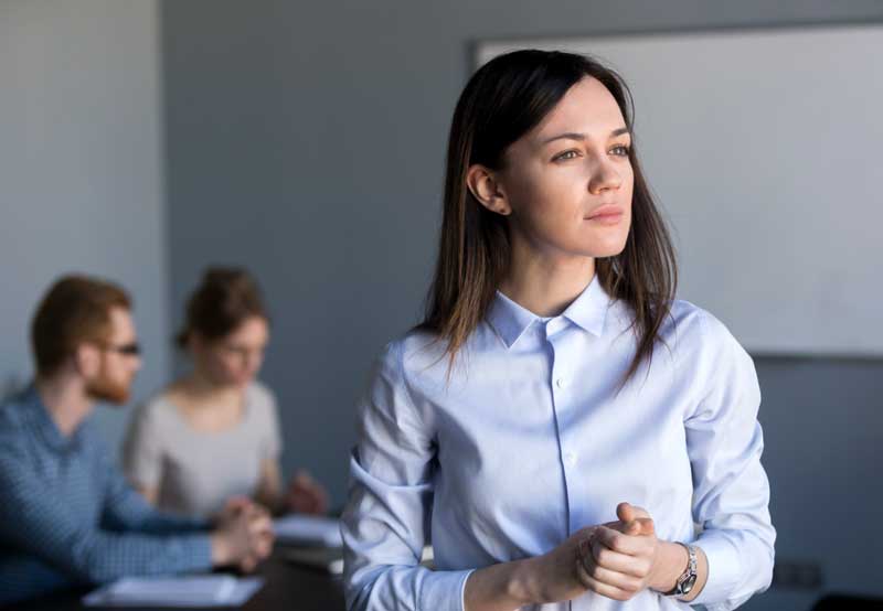 Disabled service members consider discrimination against veterans when searching for resources. woman, clasping hands, looks into distance, thinking