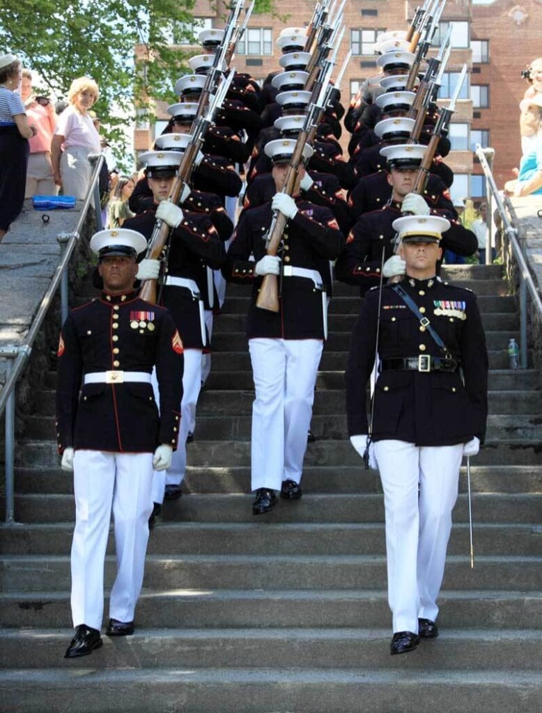 Families, what do you say to a Veteran on Veterans Day? Military servicemen walking uniformly down a set of stairs in an outside setting