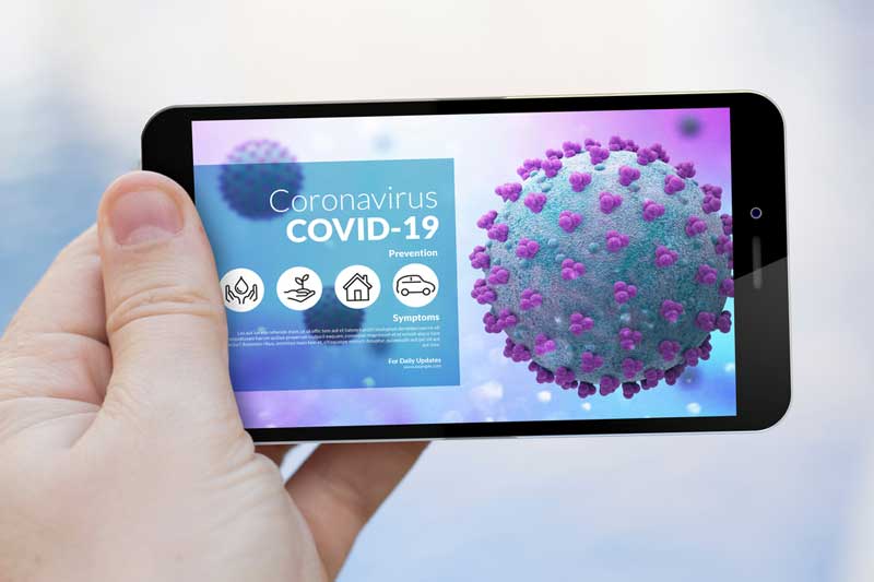 One of the leading telehealth companies displays information about COVID-19 on an iPhone. hand holding an iphone showing covid information