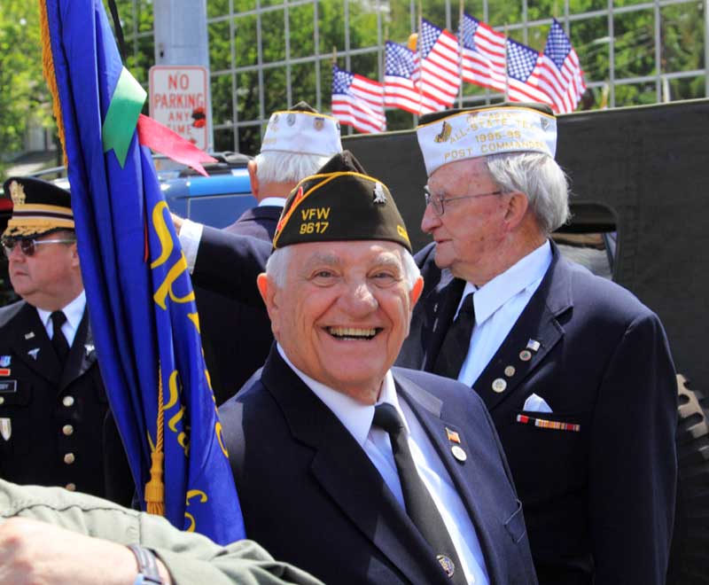 Veteran smiles at camera during a Veterans Day parade Proud Veteran smiles at camera