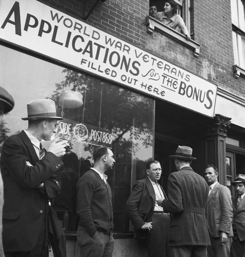 World War Veterans, pictured in black and white, standing in line for applications World War Veterans, in black and white, standing in line for applications