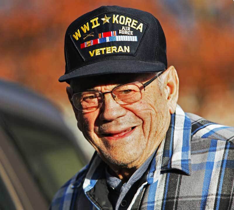 A Korean War Veteran pauses during a Veterans Day parade to smile and have his picture taken A Korean War Veteran smiles at the camera