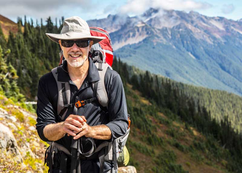 A retired Veteran, hiking, stopped to smile for a picture. retired veteran hiking