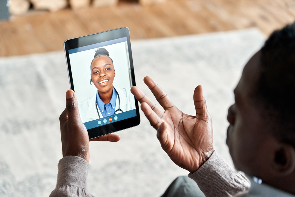 A Veteran uses a tablet to speak with a doctor from one of the leading telehealth companies. veteran speaks with a doctor from one of the leading telehealth companies