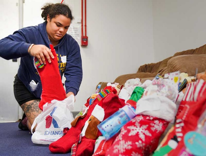 Volunteer stuffs holiday stockings 
