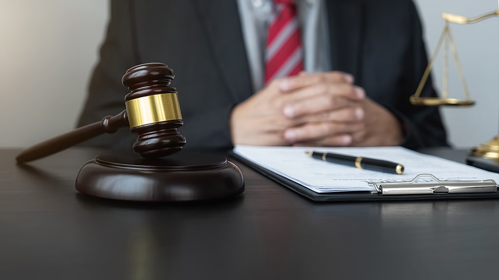 man sitting at desk performing a higher level review.