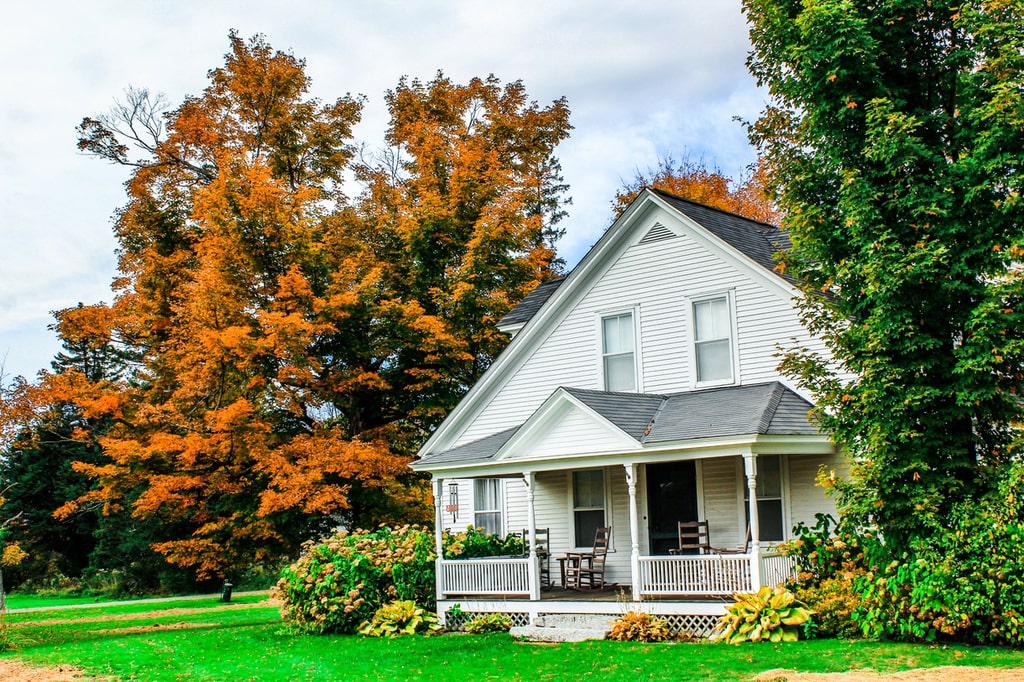 VERMONT White House with porch in autumn.