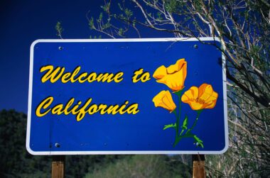 A blue Welcome to California sign.