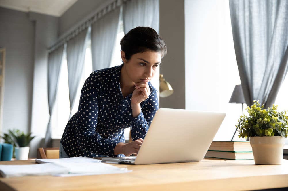 Woman looking at her laptop.