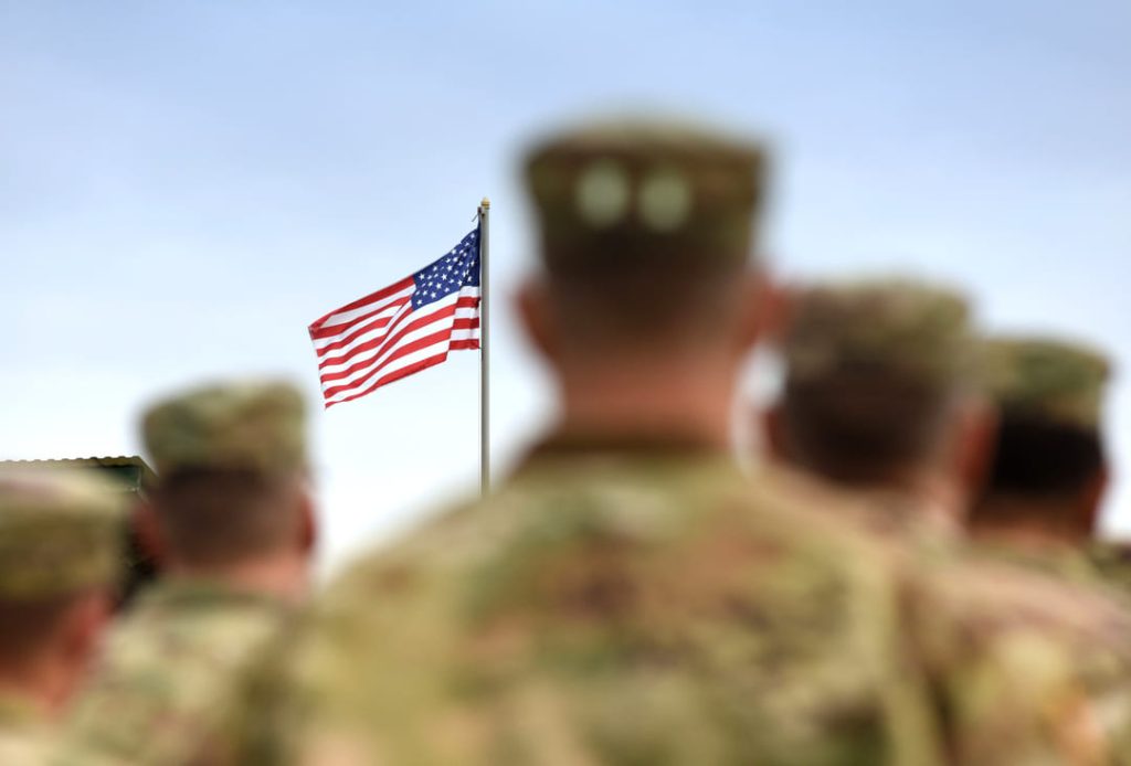 SOLDIERS LOOKING AT US FLAG