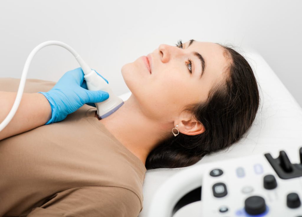 Woman lying down on hospital bed undergoing test.