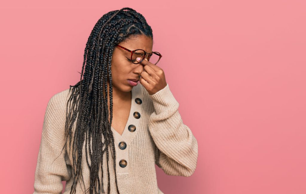 Girl with braids feeling tired and frustrated.