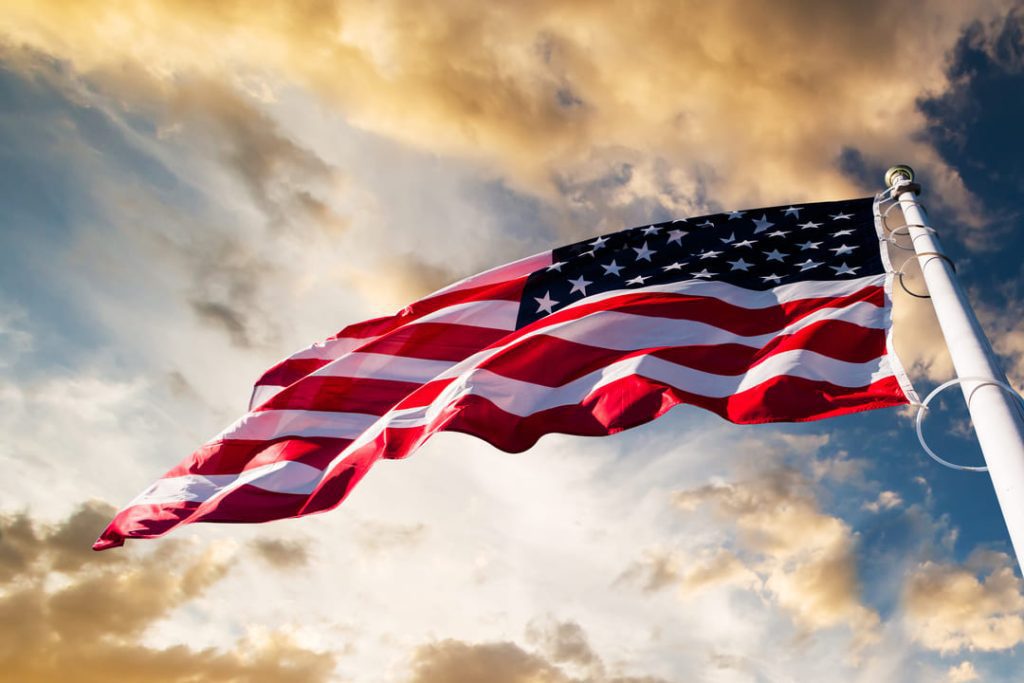 US Flag flying at sunset.