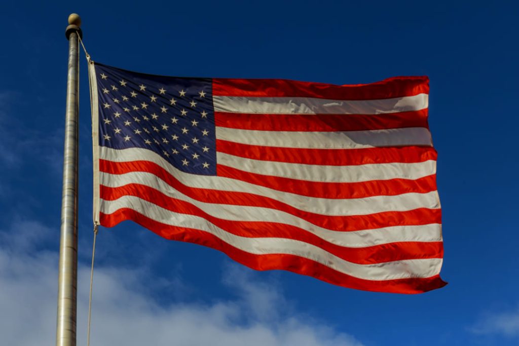 AMERICAN FLAG FLYING IN WIND.