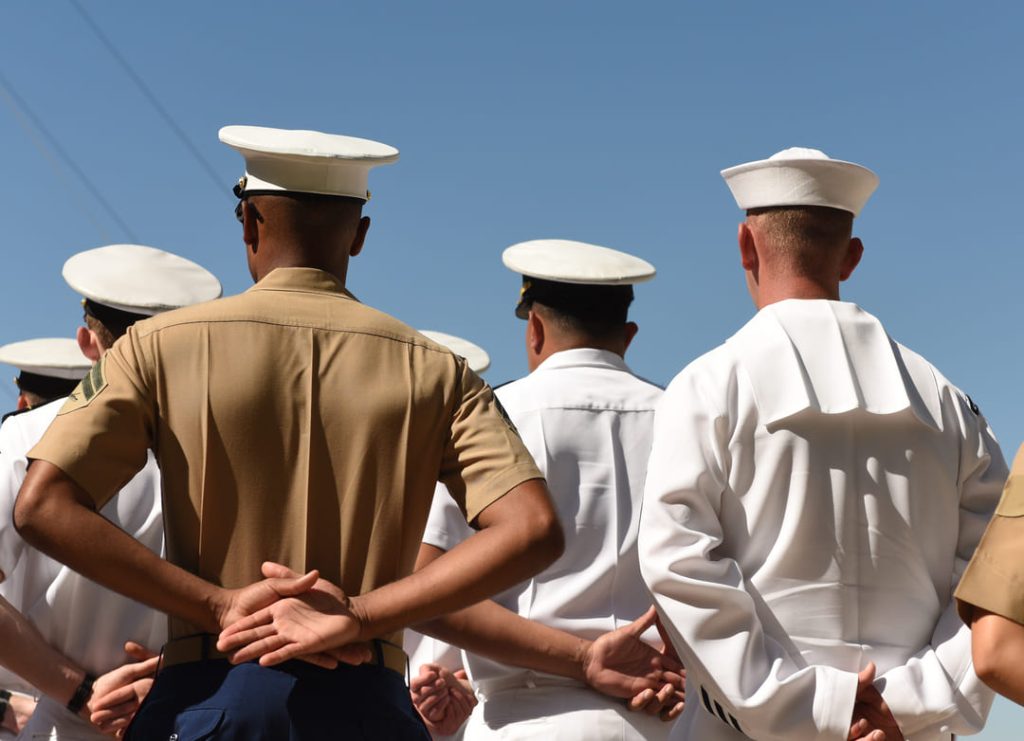 Navy sailors standing on a ship.