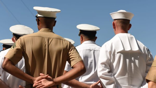 NAVY sailors standing on a ship.