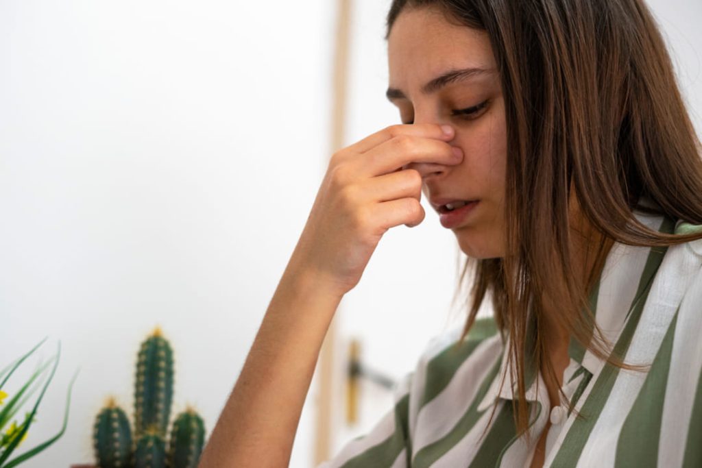 Woman suffering from a deviated septum.