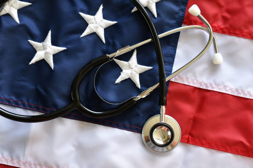 A stethoscope on top of an American flag.