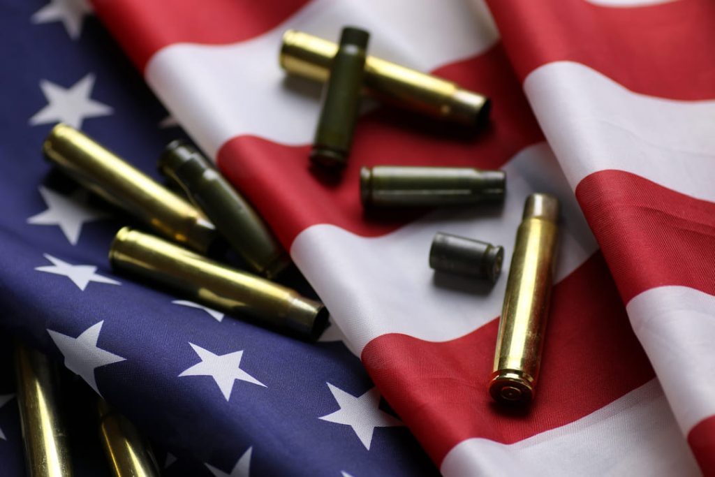Shell casings on top of an American flag.